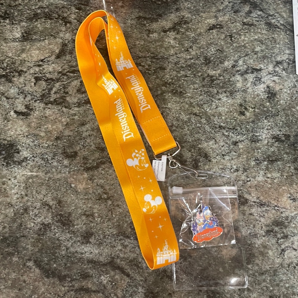 Disneyland lanyard with Donald and Daisy pin. NWT